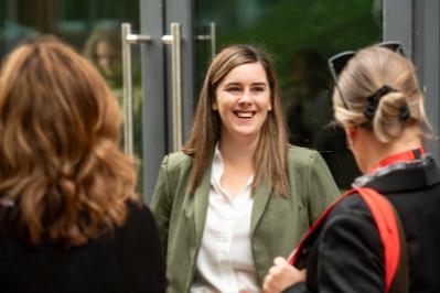 Lady laughing with two other ladies